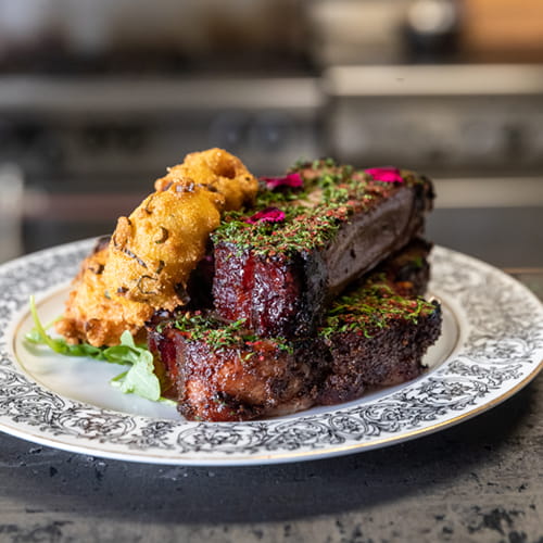 Pink Peppercorn Crusted Smoked Honey Glazed Pork Ribs with Hushpuppies Roasted Shallots - Recipe