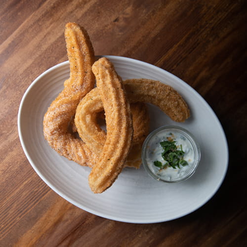 Chipotle Cinnamon Churros with Cilantro Sour Cream - Recipe